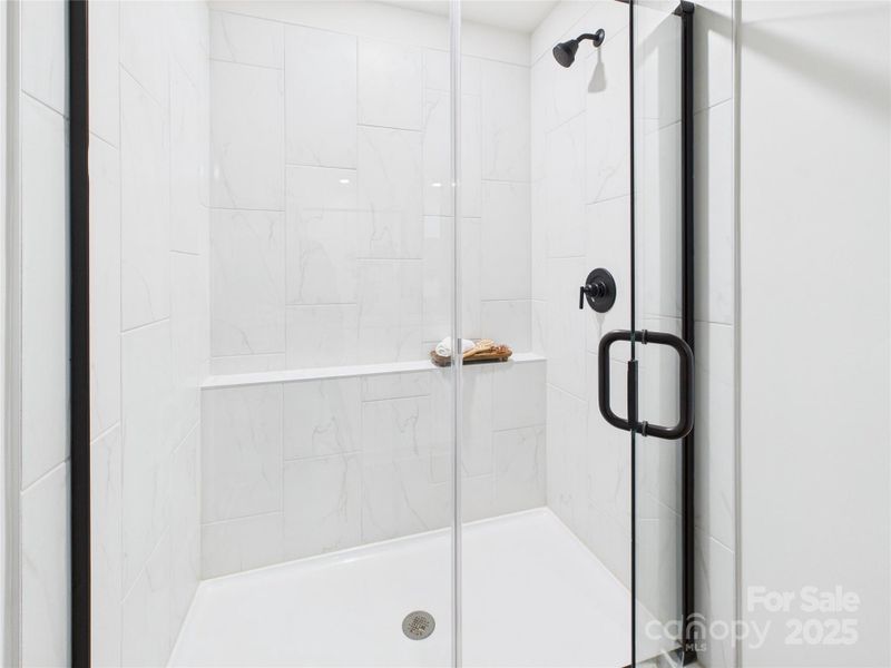 Primary shower with an upgraded modern tile.