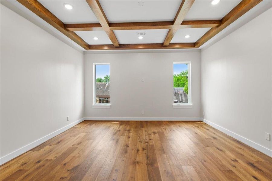 The 2nd floor media room has gorgeous oak beams and is wired for a tv between the windows overlooking back yard
