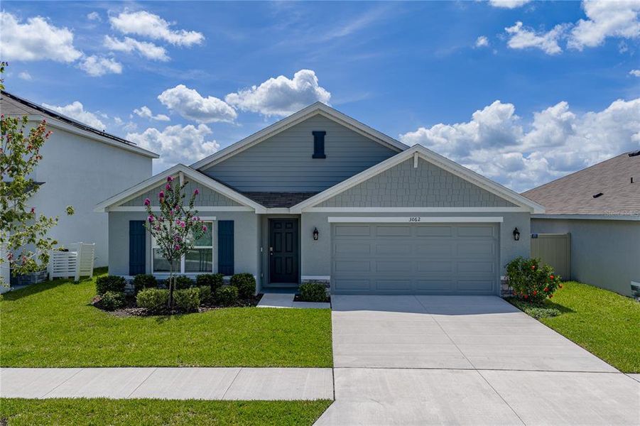Front exterior of a new home in Berry Bay, Wimauma, FL, highlighting curb appeal (Image 26).