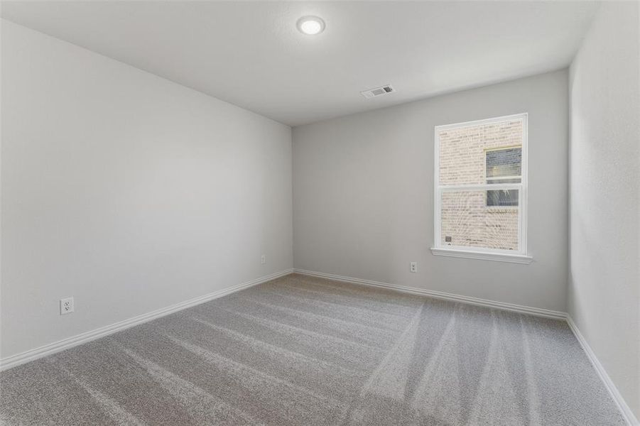 Empty room featuring light carpet