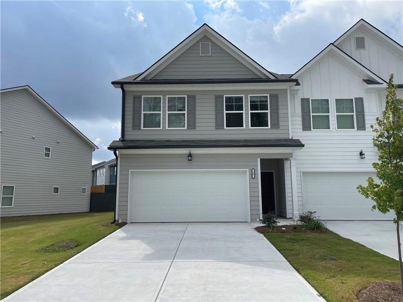 Front exterior of a new home in , Hoschton, GA, highlighting curb appeal (Image 1).