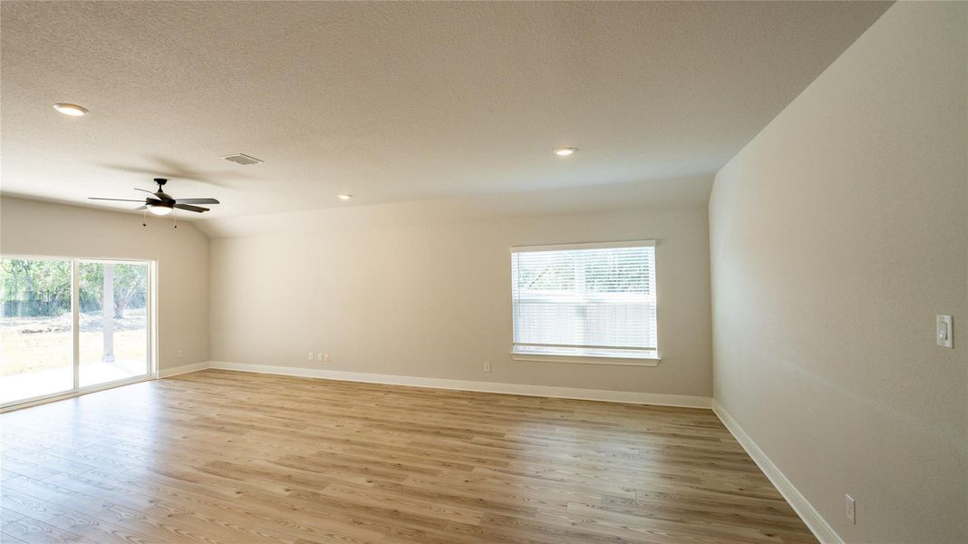Spare room featuring light wood finished floors, recessed lighting, a ceiling fan, and a textured ceiling Spare room featuring light wood finished floors, recessed lighting, a ceiling fan, and a textured ceiling