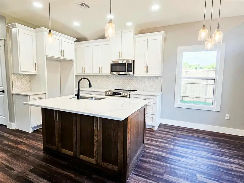 Gorgeous kitchen w/ quartz countertop and custom cabinets.