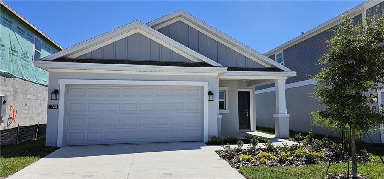 Front exterior of a new home in Cascades, Davenport, FL, highlighting curb appeal (Image 1). Front exterior of a new home in Cascades, Davenport, FL, highlighting curb appeal (Image 1).