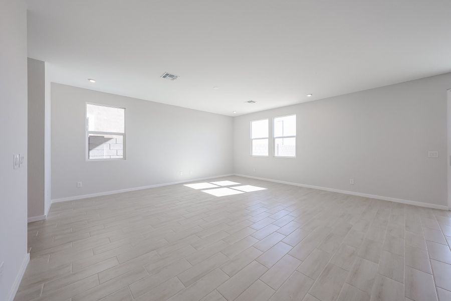A room with a wood floor and windows.