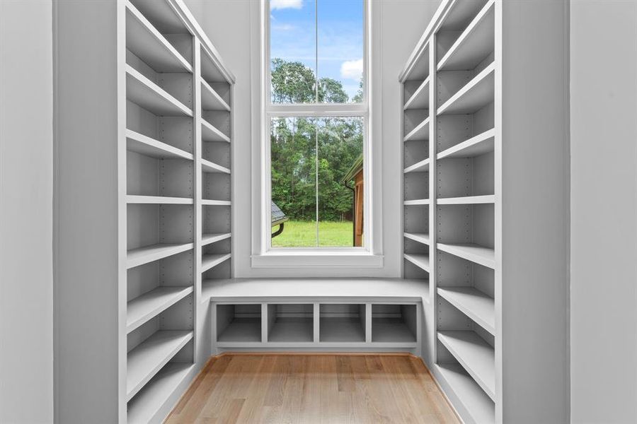 Mid stair library with built in book shelves and window seat with beautiful sweeping views of the backyard.