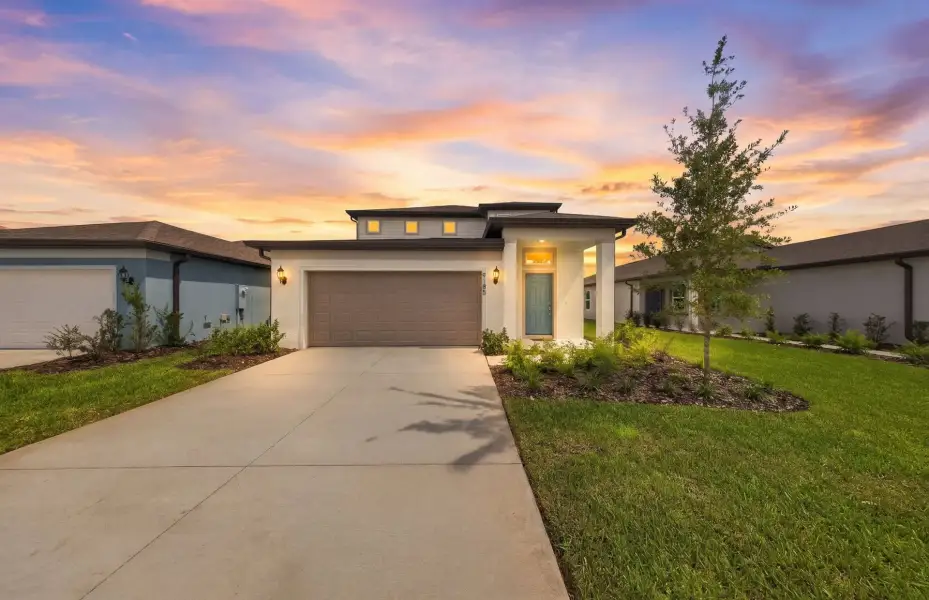 Front exterior of a new home in Twisted Oaks, Wildwood, FL, highlighting curb appeal (Image 2). Front exterior of a new home in Twisted Oaks, Wildwood, FL, highlighting curb appeal (Image 2).