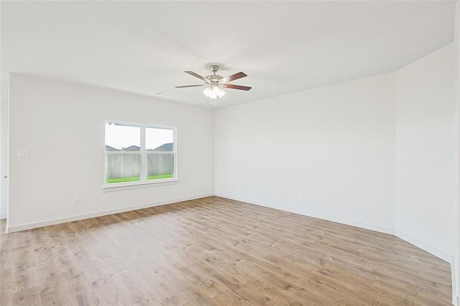 Spare room with ceiling fan and light wood-type flooring