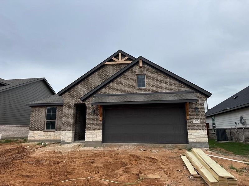 Brick and stone exterior with dark trim accents