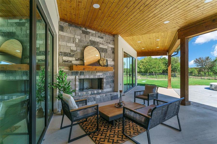 View of patio / terrace with an outdoor stone fireplace