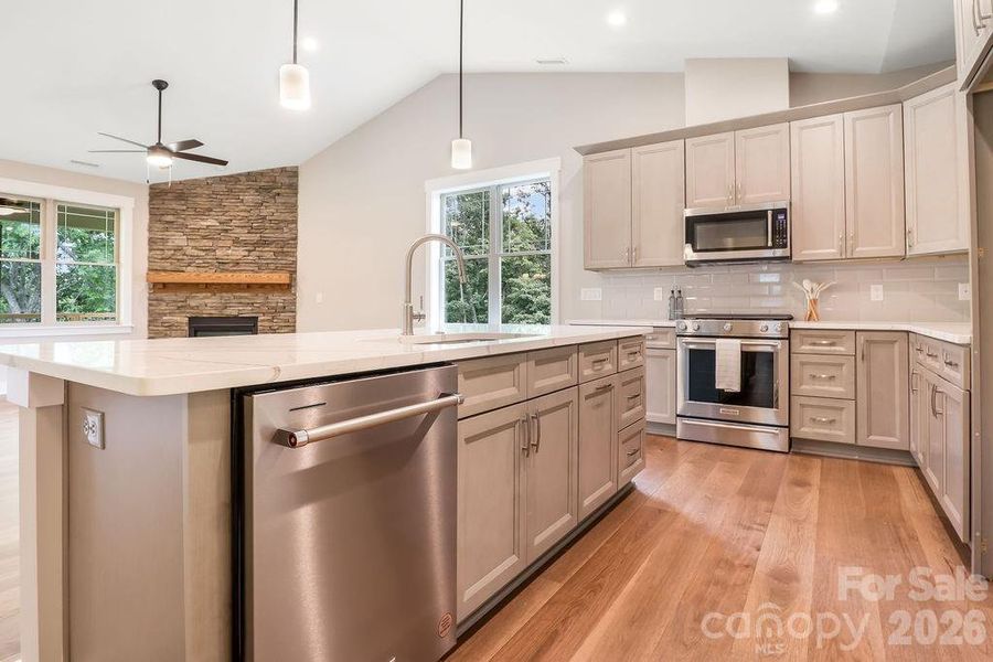 Kitchen Aid appliances; dishwasher, gas range and vented microwave all included in home.