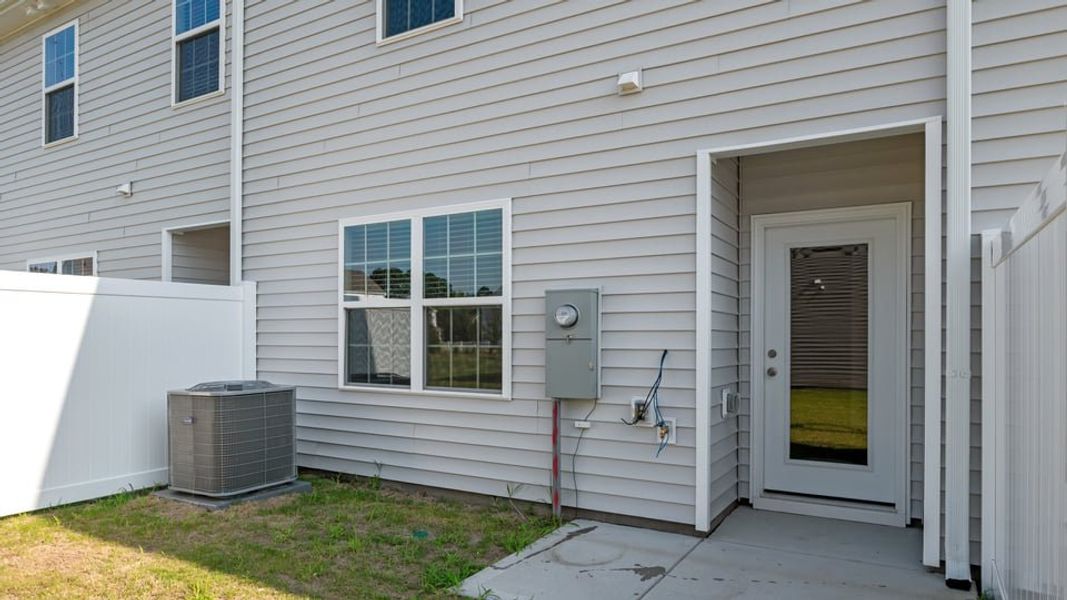 Exterior details and patio area of a home in The Townes at Ridgewood Farms, Winterville (Image 19).