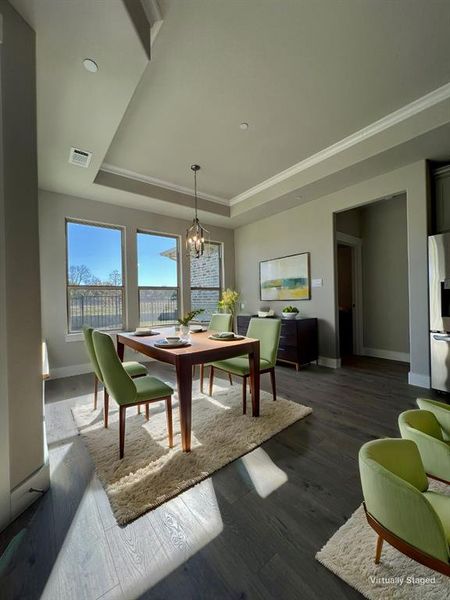 Light and bright breakfast area AI staged just off of the kitchen to get your days started off with a pretty view.