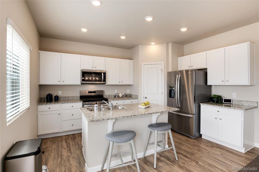 Kitchen with island and stainless appliances.