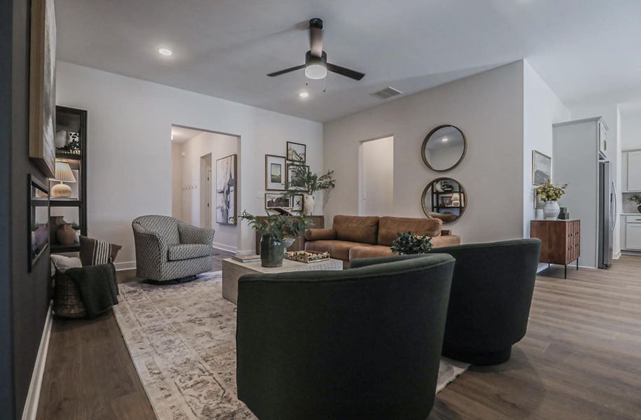 Spacious living area featuring wood-finish flooring, recessed lighting, and a ceiling fan
