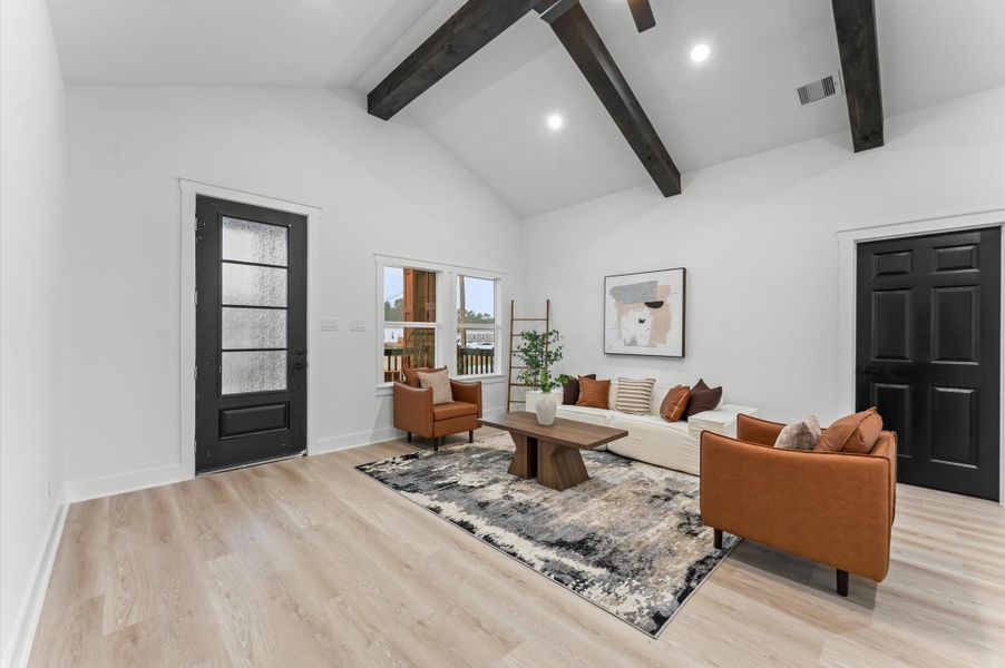 Bright and open living area with soaring cathedral ceilings and recessed lighting. Bright and open living area with soaring cathedral ceilings and recessed lighting.