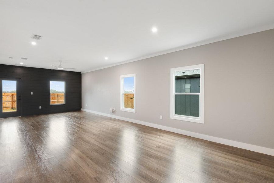 Spare room with recessed lighting, wood finished floors, crown molding, ceiling fan, and wood walls