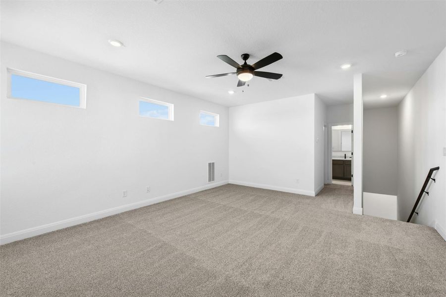 Empty room featuring light carpet, recessed lighting, and a ceiling fan