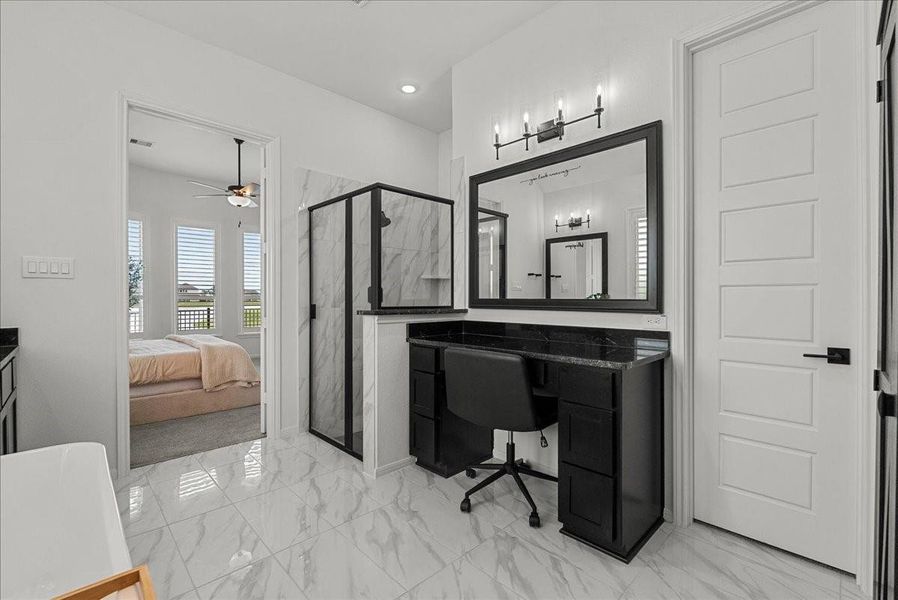 The luxurious primary en-suite bath features dual vanities, a walk-in shower, soaking tub, and separate his-and-her walk-in closets.