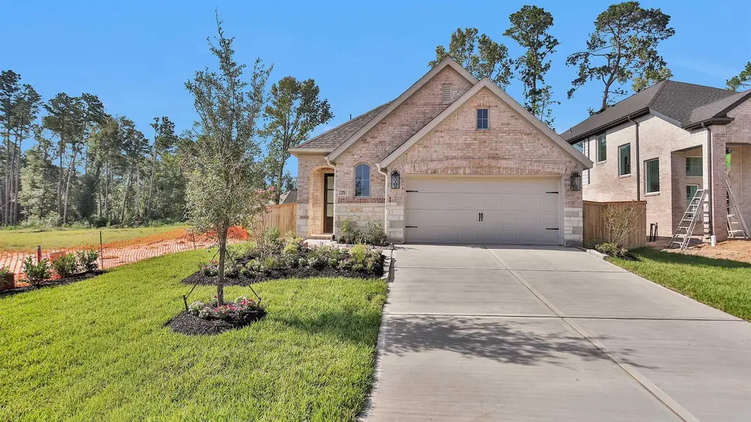 Front exterior of a new home in The Woodlands Hills 40', Willis, TX, highlighting curb appeal (Image 1). Front exterior of a new home in The Woodlands Hills 40', Willis, TX, highlighting curb appeal (Image 1).