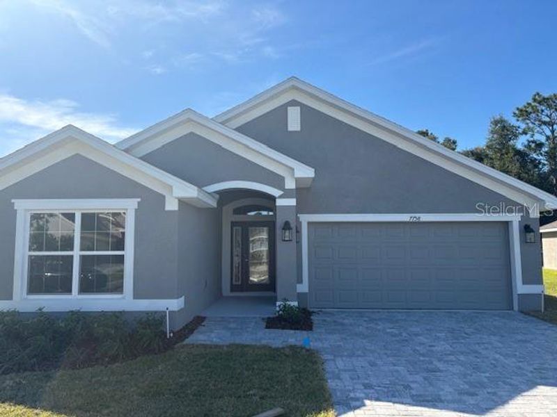 Front exterior of a new home in Juliette Falls, Dunnellon, FL, highlighting curb appeal (Image 11).