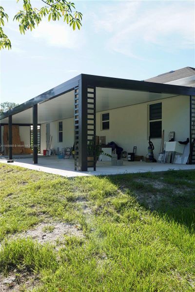 Front exterior of a new home in , Lehigh Acres, FL, highlighting curb appeal (Image 1).