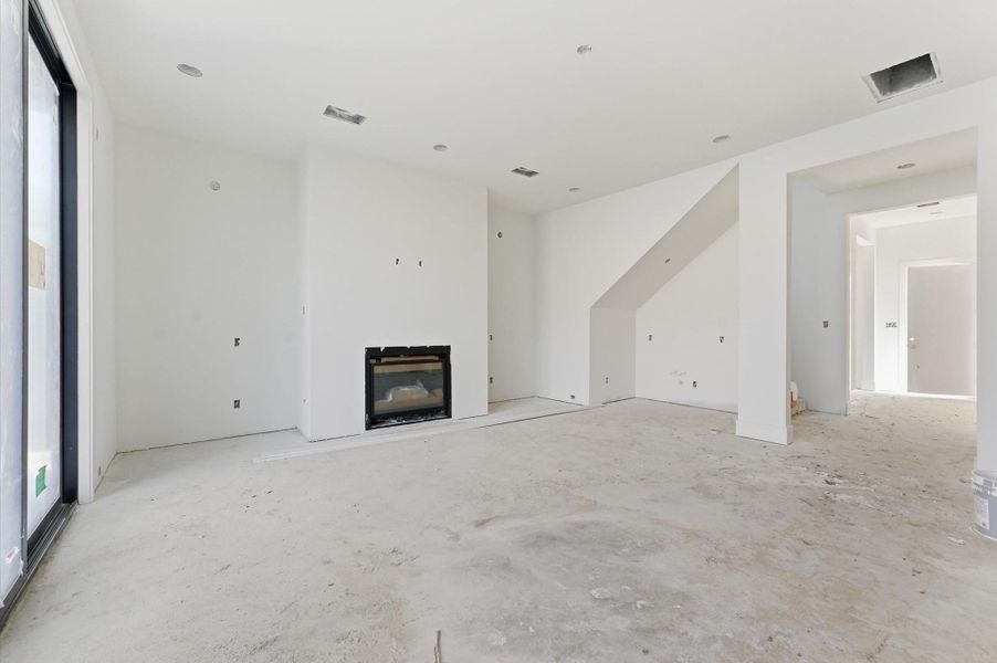 The living room includes a dry bar, perfect for entertaining guests. The living room includes a dry bar, perfect for entertaining guests.