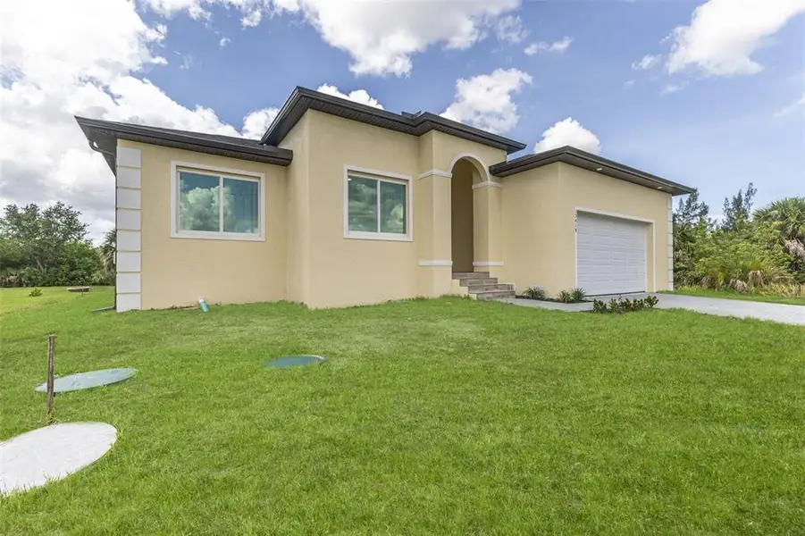 Front exterior of a new home in , Port Charlotte, FL, highlighting curb appeal (Image 2). Front exterior of a new home in , Port Charlotte, FL, highlighting curb appeal (Image 2).