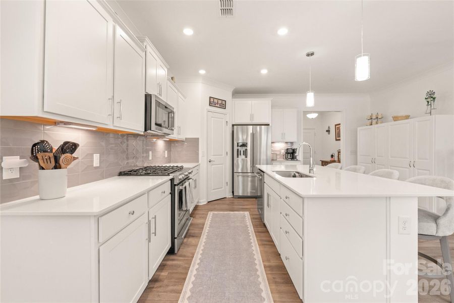 Large island with sink, tons of counter space, Abundant storage, and nice pantry = a great Kitchen area