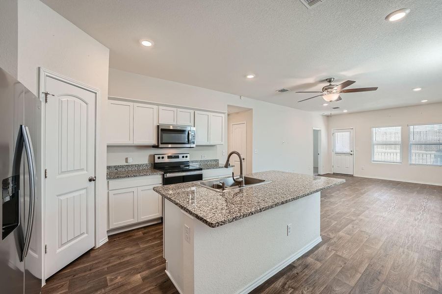 Open kitchen with large pantry and granite counters