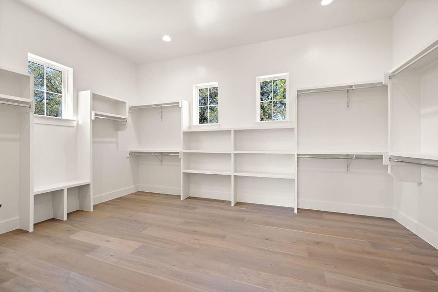 Walk in closet with wood finished floors