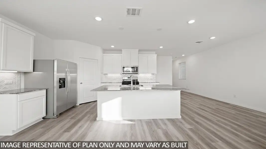 Kitchen featuring an island with a sink, stainless steel appliances, recessed lighting, white cabinetry, and wood-finish flooring