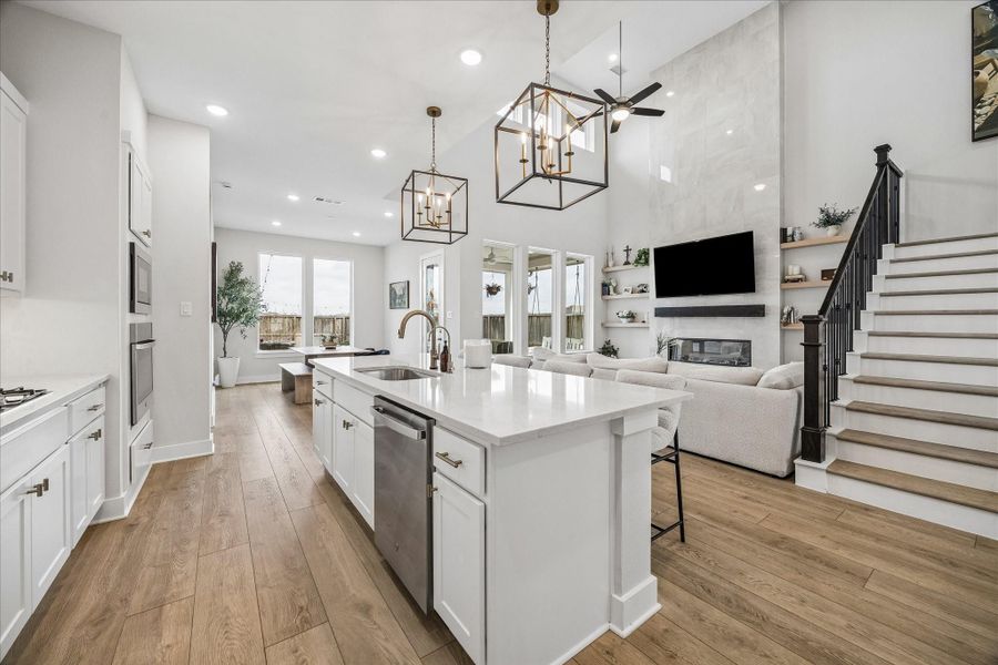 From the kitchen, enjoy clear sightlines across the island into the living and dining spaces, enhancing the home’s bright and connected main living area.