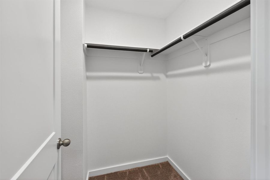 Spacious walk-in closet with ample hanging space and a clean, organized layout designed for everyday convenience. Spacious walk-in closet with ample hanging space and a clean, organized layout designed for everyday convenience.
