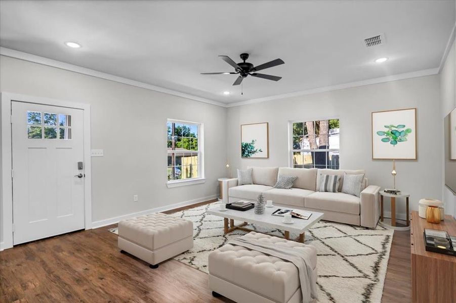 Living room with wood finished floors, plenty of natural light, ornamental molding, ceiling fan, and recessed lighting