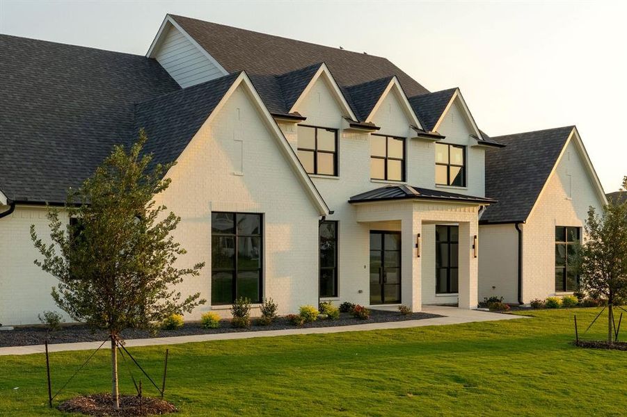 View of front of property with brick siding, a front lawn, and roof with shingles View of front of property with brick siding, a front lawn, and roof with shingles