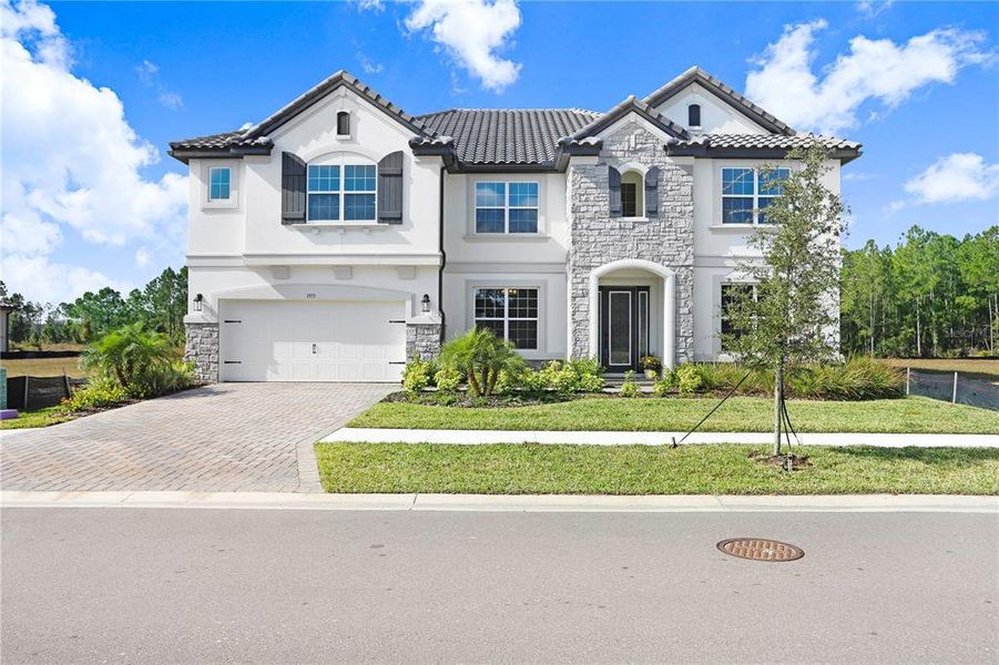 Front exterior of a new home in Shortgrass at Two Rivers, Zephyrhills, FL, highlighting curb appeal (Image 33). Front exterior of a new home in Shortgrass at Two Rivers, Zephyrhills, FL, highlighting curb appeal (Image 33).