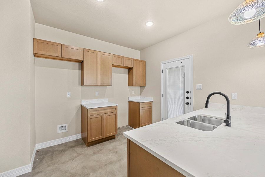 Kitchen featuring pendant lighting and a peninsula