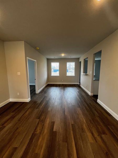 Spare room featuring dark wood-type flooring