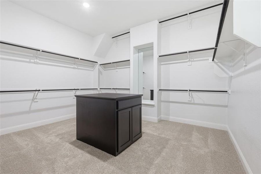 Walk in closet featuring light carpet Walk in closet featuring light carpet