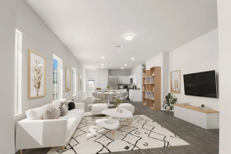 Image of a living room rendering with white furniture, a rug, an entertainment center, mounted TV and wall decor