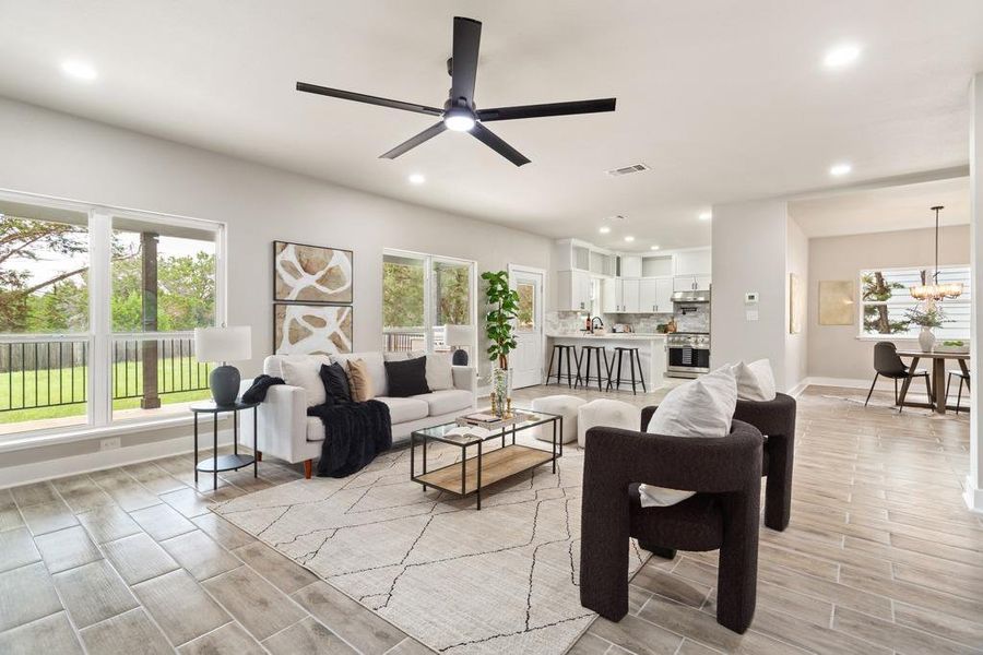 An airy great room combines kitchen, dining, and living with serene views of the outdoors. An airy great room combines kitchen, dining, and living with serene views of the outdoors.