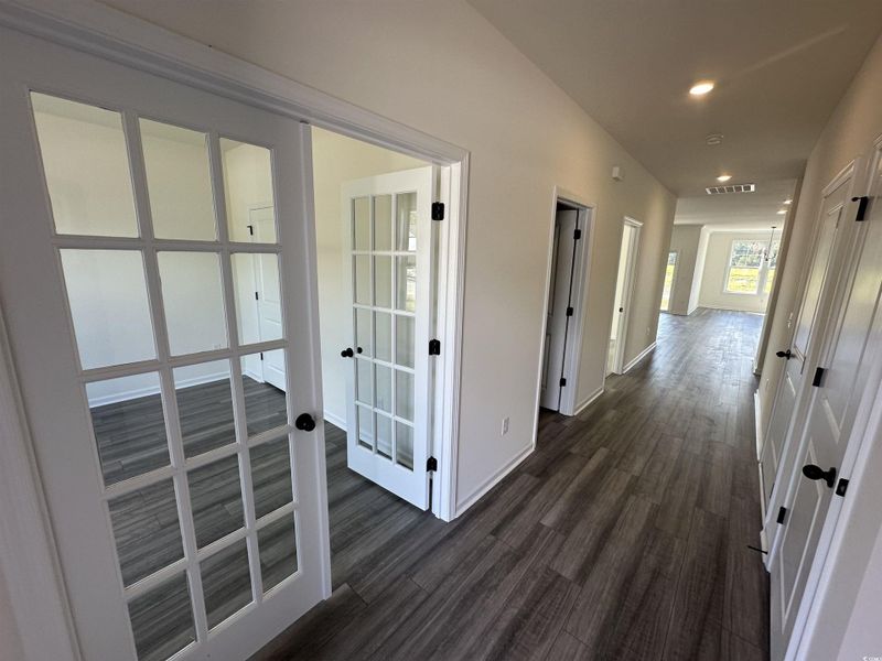 Corridor with recessed lighting and dark wood-type flooring Corridor with recessed lighting and dark wood-type flooring