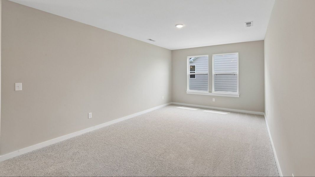 Second Floor Loft area with windows and carpet Second Floor Loft area with windows and carpet