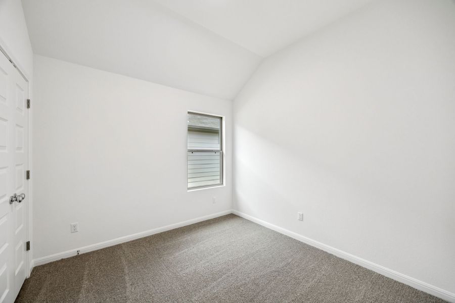 Bedroom in the Spruce home plan by Trophy Signature Homes - REPRESENTATIVE PHOTO