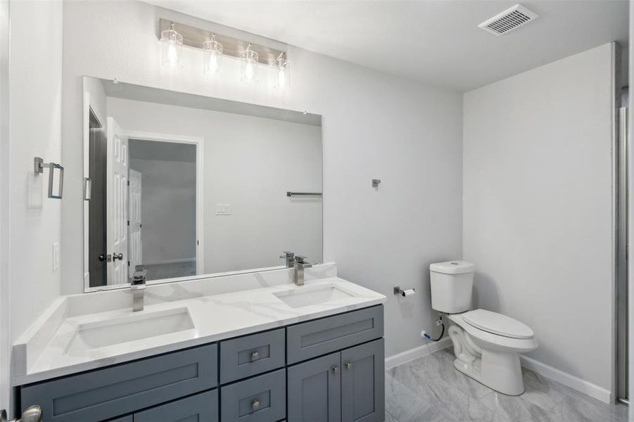 Bathroom featuring vanity and toilet