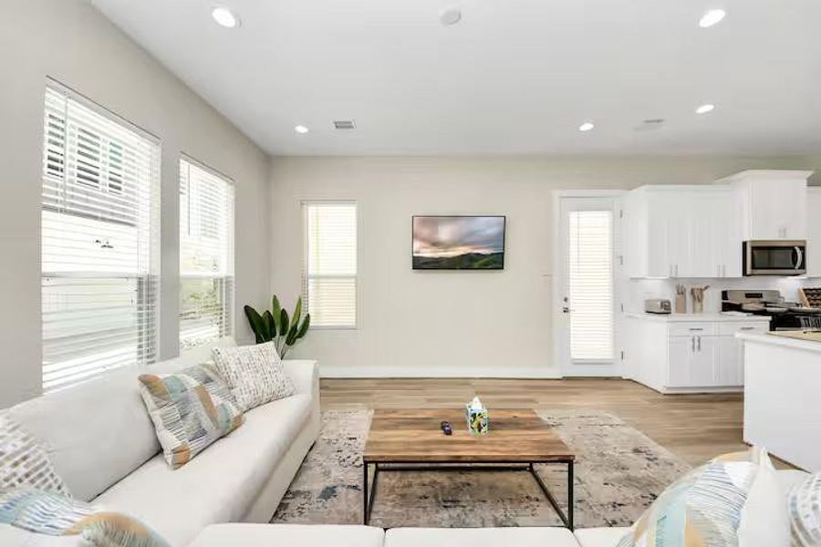 A clean, bright kitchen pairs white cabinetry and countertops with stainless steel appliances for a look that is easy to move into and make your own.