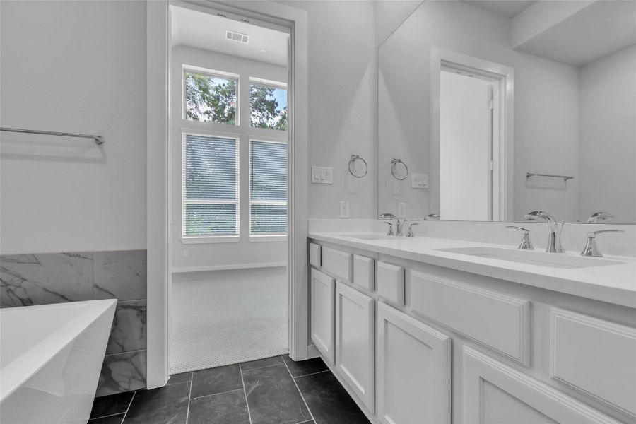 The primary ensuite bath offers generous space and dual sinks.
