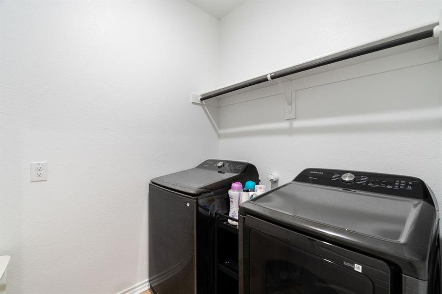 Laundry room featuring washer and dryer and baseboards Laundry room featuring washer and dryer and baseboards