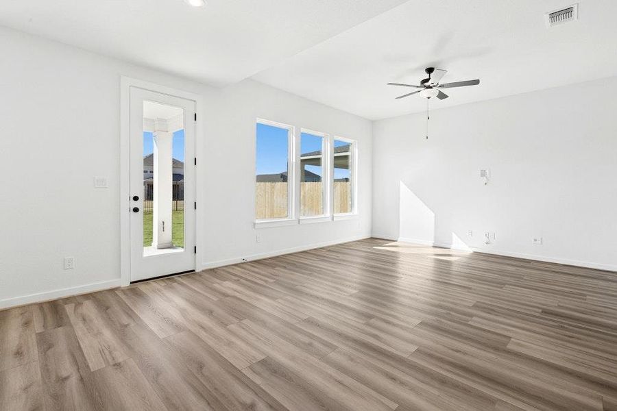 Unfurnished living room with light wood finished floors and a ceiling fan